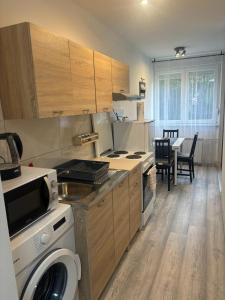 a kitchen with a stove and a table with chairs at Studio apartman Stefi in Samobor