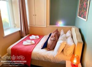 a bed with towels on it in a room at Apartment 1 West County by Prestige Properties SA in Millom