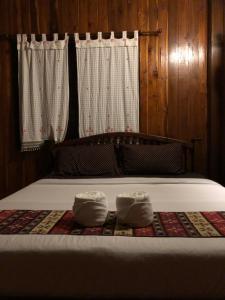 a bed with two towels sitting on top of it at Lampang homestay2 in Lampang