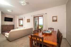 Appartamento Bellavista في Telti: غرفة معيشة مع طاولة وأريكة