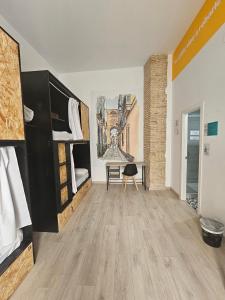 a room with two bunk beds and a desk at Planeta Cadiz Hostel in Cádiz