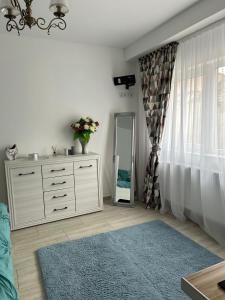 a dressing room with a dresser and a mirror at Studio G&A Hunedoara Apartment in Hunedoara