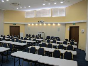 an empty room with tables and chairs and a podium at Аполлонія in Poltava