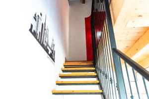 a staircase in a house with a red wall at Residence IL Villaggio del Re in Corropoli