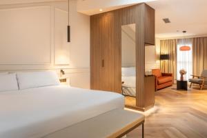 a bedroom with a bed and a living room at Bilder Boutique Hotel in Bilbao +37 photos