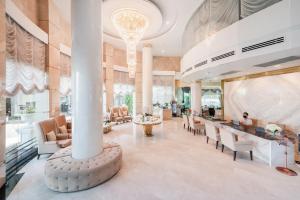 a lobby of a hotel with chairs and a column at Royal Pavilion Hua Hin in Hua Hin