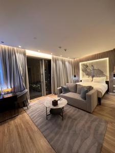 a living room with a couch and a bed at OSTAY -Fashion Avenue Dubai mall in Dubai