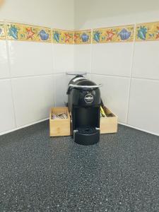 a coffee maker sitting on the floor in a room at Coral Suite in Resort Complex in Agnes Water