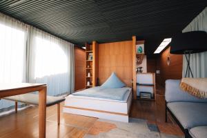 a bedroom with a bed and a table and a desk at JULIA - Schwimmendes Apartment in Berlin