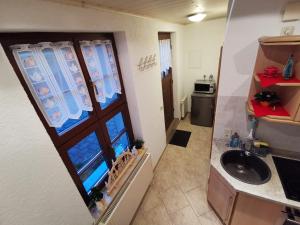 a small bathroom with a sink and a mirror at Schnorr-Villa in Schneeberg