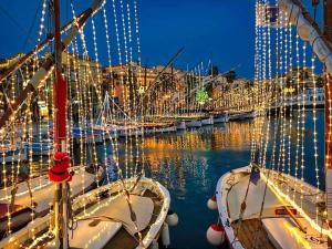 a group of boats docked in a harbor with christmas lights at Studio 35m2, 500m de la plage + parking gratuit. in Six-Fours-les-Plages
