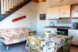 a kitchen and dining room with a table and a couch at Residence IL Villaggio del Re in Corropoli