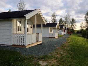 a row of white houses in a yard at Langnes Camping, Grong in Grong
