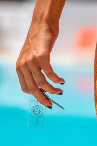 a close up of a hand holding a cigarette at Islands View in Nydri