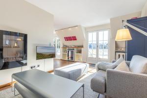 a living room with a couch and a table at Feriendomizil App 3 in Wenningstedt