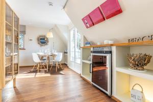 a kitchen and dining room with a table and chairs at Feriendomizil App 3 in Wenningstedt +21 photos