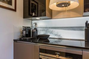 a kitchen with a counter top with a coffee maker at SYLThouse in Wenningstedt +46 photos