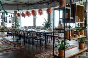 a dining room with a long table and chairs at Orbi City Premium Apartments in Batumi