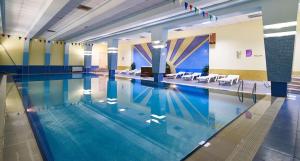 a large swimming pool in a building at Orbi City Premium Apartments in Batumi