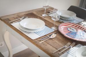 a wooden table with plates and silverware on it at Engelskoje in Wenningstedt