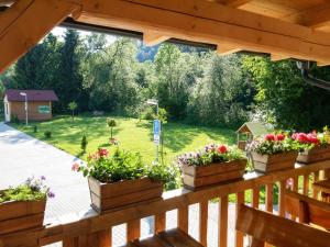 a view of a garden from a porch with flowers at Penzión Mlynárka in Rajecké Teplice