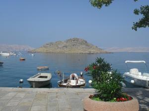 two boats are docked in a body of water at Rooms Natalija in Sveti Juraj