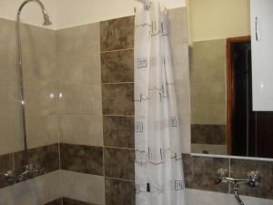 a shower with a white shower curtain in a bathroom at Rooms Natalija in Sveti Juraj +29 photos