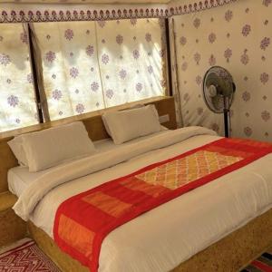 a bedroom with a large bed with a window at Night Stay Camp in Jaisalmer