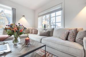 a living room with a couch and a table with a candle at Spuren im Sand in Wenningstedt