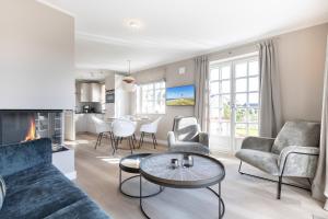 a living room with a couch and a table at Lille Wung in Wenningstedt