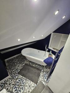 a bathroom with a white toilet and a blue wall at Startop Farmhouse in Marsworth