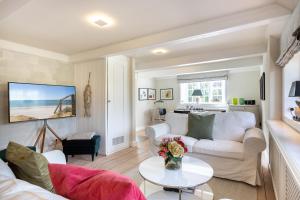 a living room with a white couch and a table at Kampende II in Tinnum