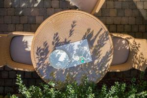 a wicker chair with a mirror on it at Fewo Carlotta in Wenningstedt