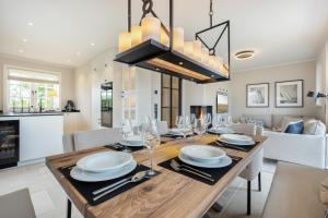 a dining room and living room with a wooden table at Fien to Huus in Wenningstedt