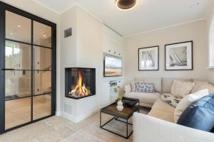 a living room with a couch and a fireplace at Fien to Huus in Wenningstedt +58 photos