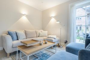 a living room with a couch and a coffee table at Beachmemories in Wenningstedt