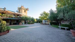 a cobblestone street with a bench and a building at Heliopolis Camping & Village in Pineto