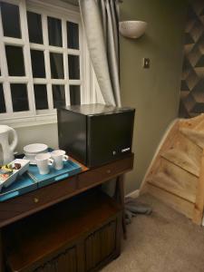 a room with a table with cups and dishes on it at Startop Farmhouse in Marsworth