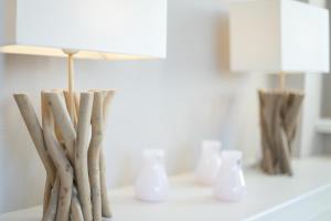 a table with a lamp and some branches on it at Windlicht in Munkmarsch +15 photos