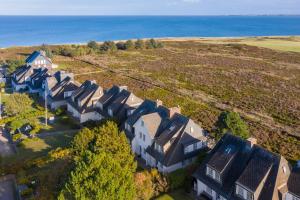 an aerial view of a house with the ocean in the background at Wattblick in Munkmarsch