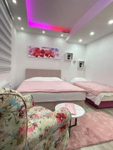 a bedroom with two beds and a table and chairs at Apartmani Porodica Karalić Vlašić in Vlasic