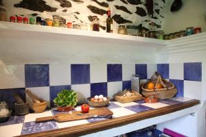 a kitchen counter with vegetables and other items on it at Cortijo rural El Albercón - Capileira - Alpujarra Rural in Capileira