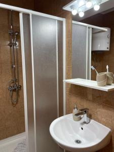 a bathroom with a sink and a shower at Apartmani Porodica Karalić Vlašić in Vlasic +37 photos