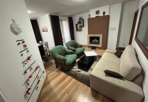 a living room with a couch and a christmas tree at Marina Apartment in Bansko