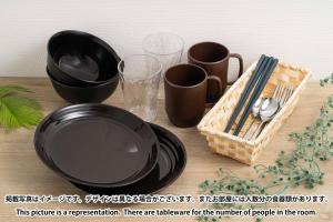 a table with black plates and cups and a basket at FL Residence Jingu Gyoen IV in Tokyo