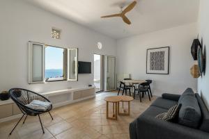 a living room with a couch and a table at La Chapelle Est in Agios Romanos