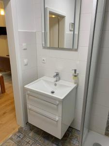 a bathroom with a sink and a mirror at Klein aber Fein mitten in Binz in Binz