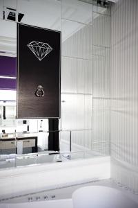 a bathroom with a sink and a picture of a diamond at Mirax Boutique Hotel in Kharkiv