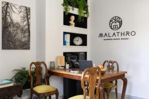 an office with a wooden desk and chairs at Malathro Olympus Guest House in Díon