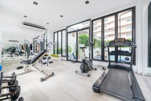 a gym with treadmills and cardio equipment in a building at Royal Pavilion Hua Hin in Hua Hin